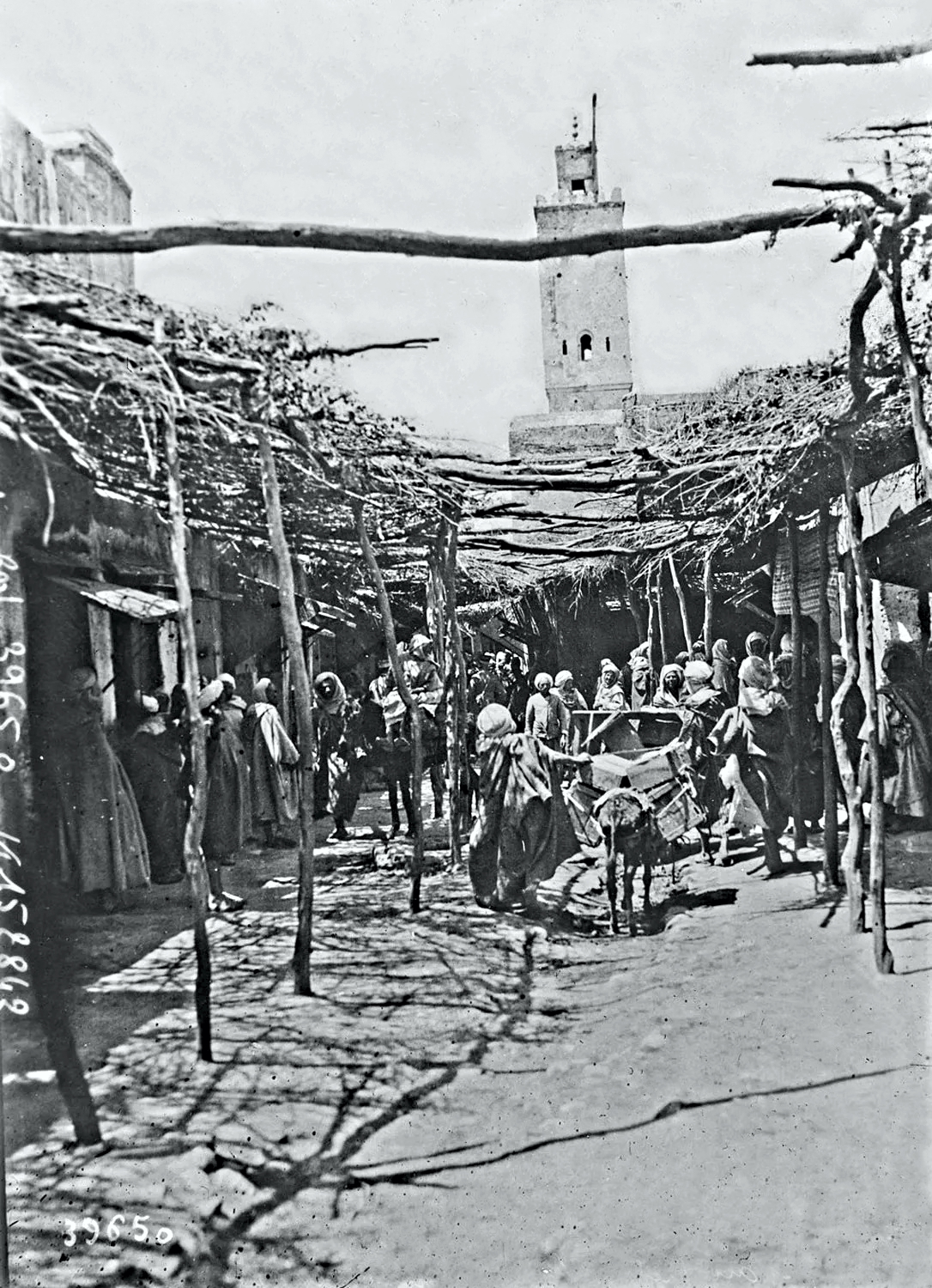 A street in Taza with the mosque minaret in the background.