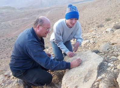 Dan Gibson and one of his sons trace out graffiti in southern Jordan. (2001)