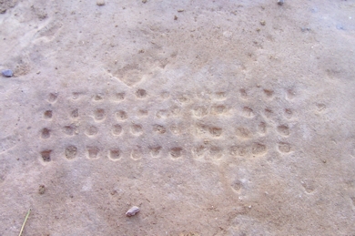 You can see a typical 4 x 12 playing board. This one was found near the Dier monument in Petra, and is typical of the most common type of game in ancient Petra. Other game boards included: 7 x 7 and 7 x 8 layouts as well as 8 x 14.